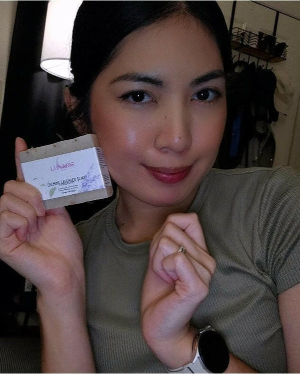 Woman holding a lavender soap bar with a neutral background