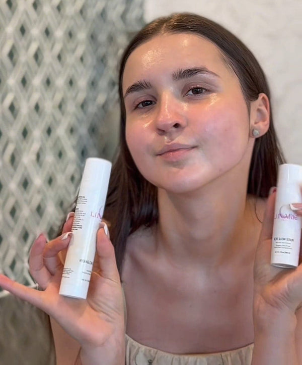 Woman holding two skincare products against a neutral background