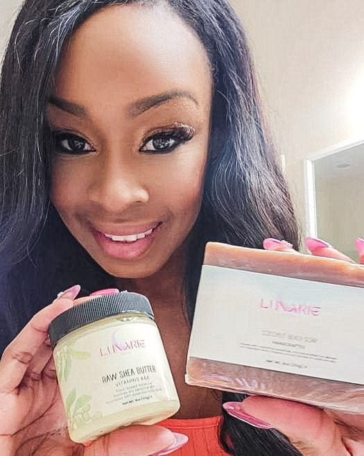 Woman holding a jar and a box of Clinique products